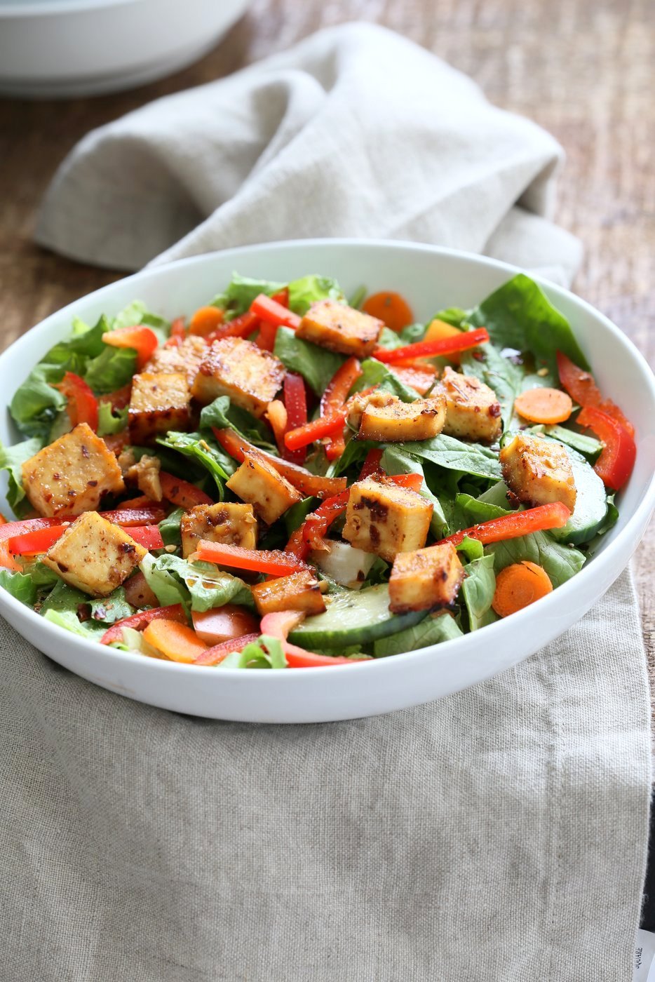 Crunchy Asian Salad With Baked Tofu & Garlic Soy Maple Dressing. Marinated and Baked Tofu over Crunchy Greens, peppers and carrots. Vegan Asian Salad. Vegan Gluten-free Recipe | VeganRicha.com