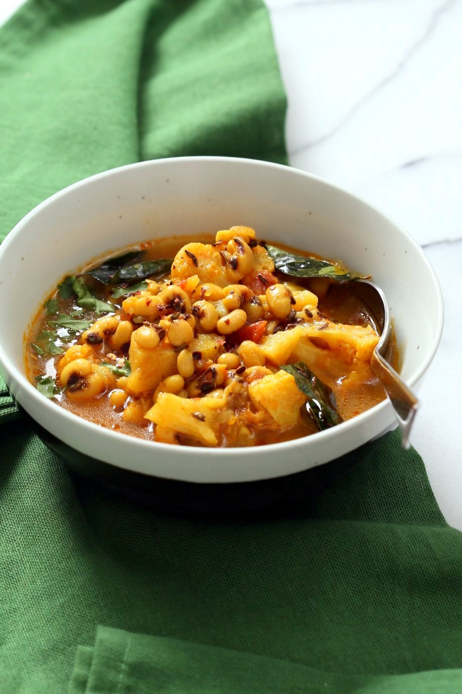 This coconutty Black Eyed Pea stew with Cauliflower and Potatoes is hearty and delicious. Instant Pot Black Eyed Pea Curry with vegetables. Saucepan Option. Vegetarian Black Eyed Peas Recipe | VeganRicha.com