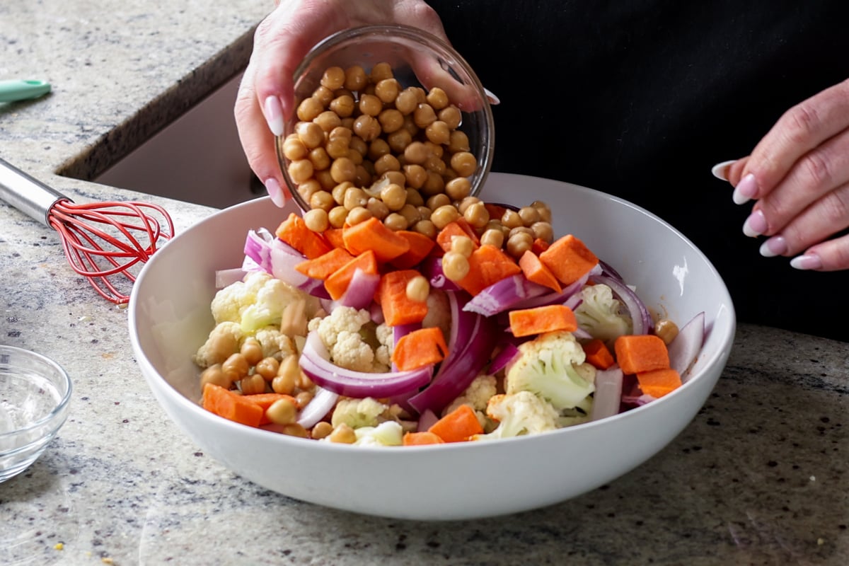 adding veggies and chickpeas to the marinade