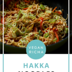 Hakka noodles in the pan after garnishing with scallions, text overlay