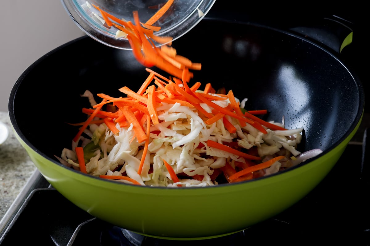 adding the veggies to the pan