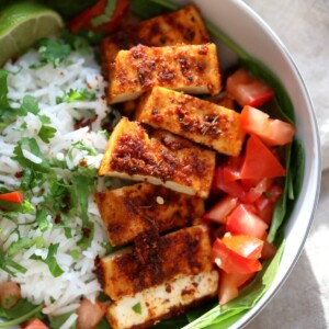 Cajun Tofu with Cilantro Lime Rice. Baked Cajun Spiced Tofu, over greens, cilantro lime rice, and tomatoes. Easy Spicy Bowl. Vegan Gluten-free Nut-free Recipe. Use Chickpea tofu to make soy-free. | VeganRicha.com