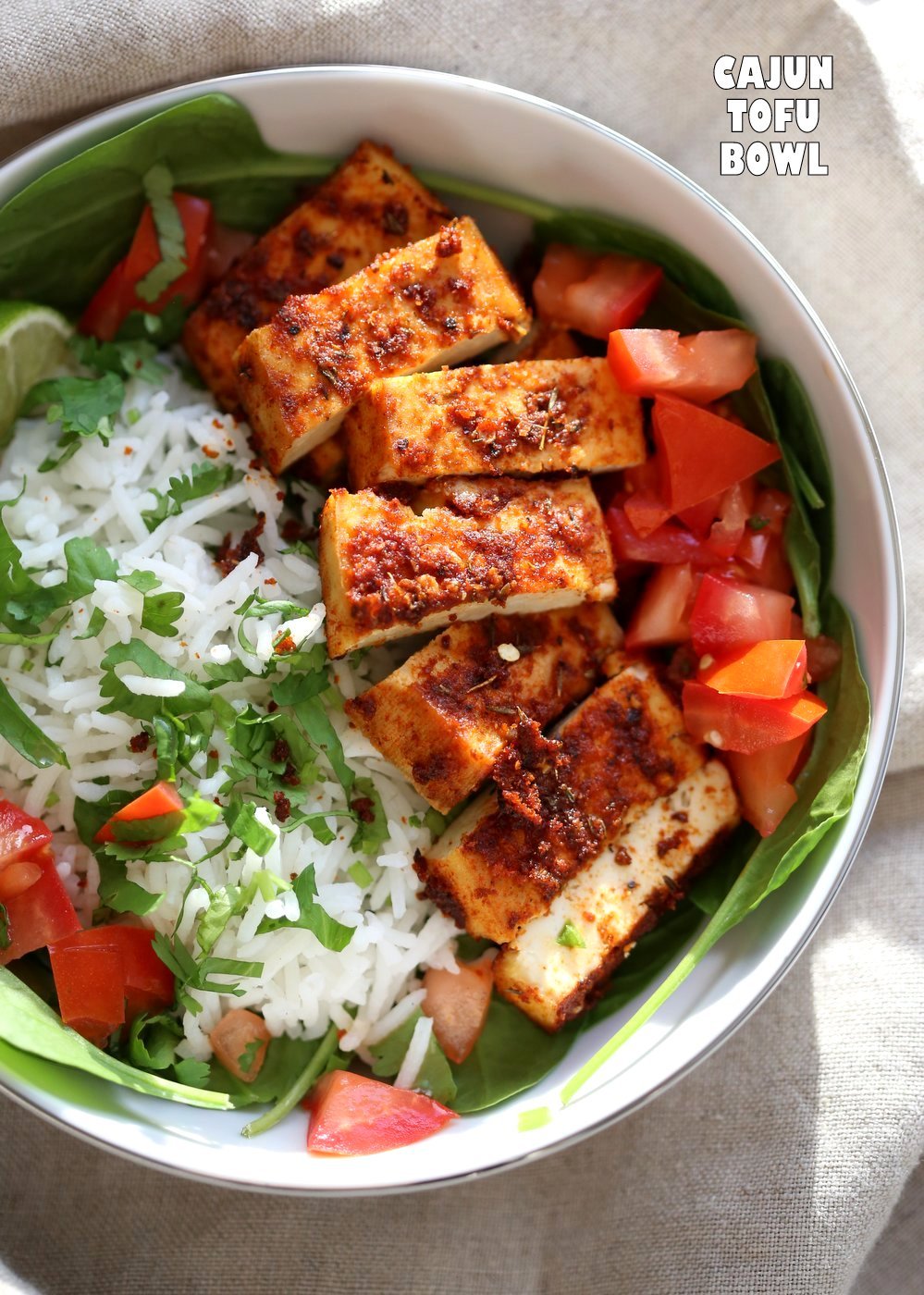 Cajun Tofu with Cilantro Lime Rice. Baked Cajun Spiced Tofu, over greens, cilantro lime rice, and tomatoes. Easy Spicy Bowl. Vegan Gluten-free Nut-free Recipe. Use Chickpea tofu to make soy-free. | VeganRicha.com