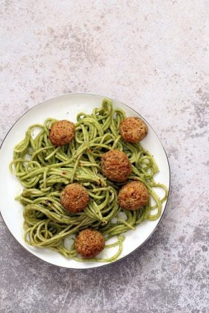 Amazingย Pesto Spaghetti with Vegan Meatballs made with Chickpeas. Vegetarian Chickpea Walnut "meatballs" over pesto pasta. Ready in 40 Minutes. Vegan Soyfree Recipe. Can be Glutenfree | VeganRicha.com