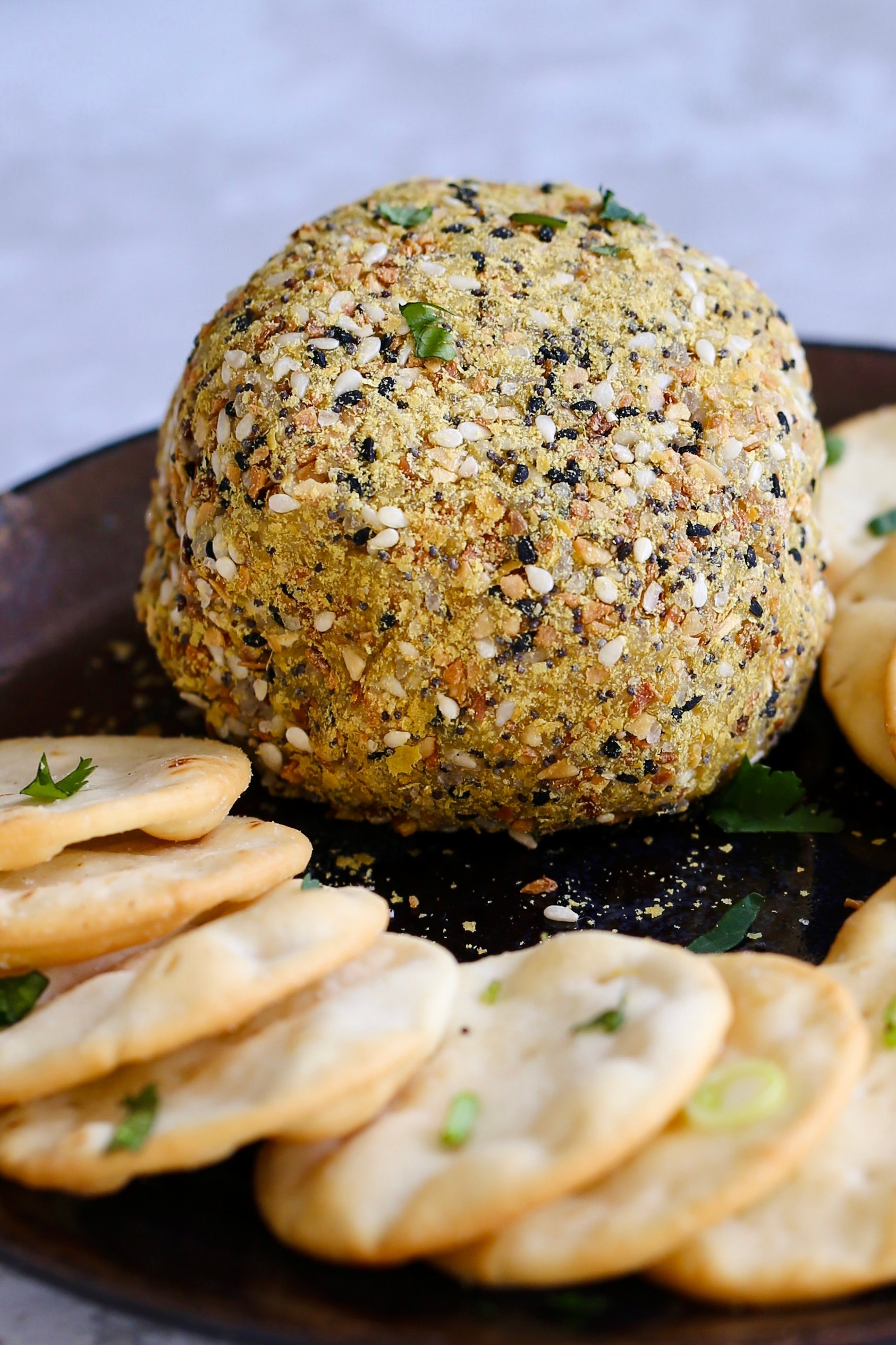 Side view of Everything bagel Seasoning coated Vegan Cheese Ball.” data-pin-description=“ Everything Bagel vegan cheeseball. No soaking, blending, straining needed! 10 minute vegan cheese ball. Gluten-free. Can be soy-free #vegan #cheese #veganricha | VeganRicha.com