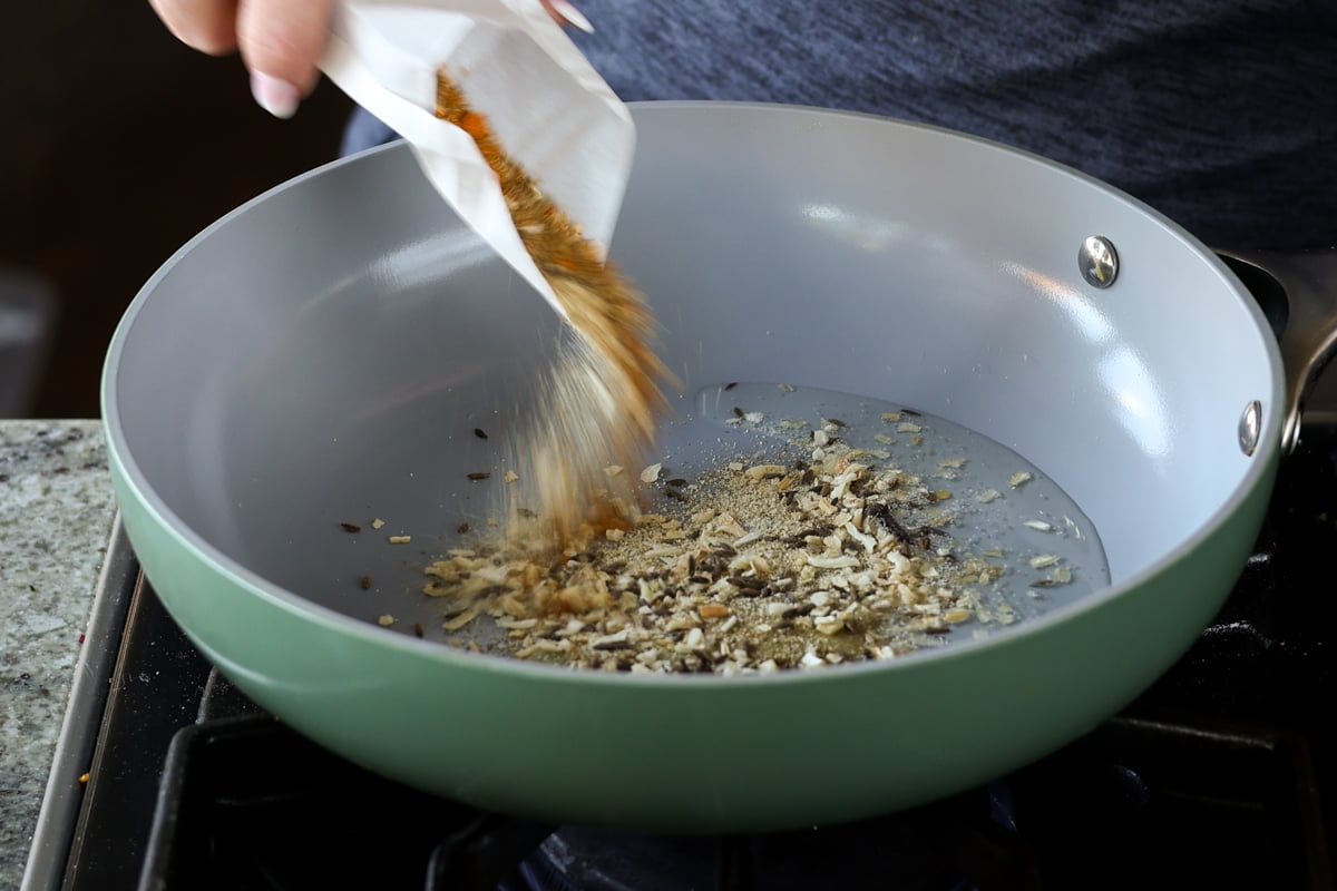 adding spice mix to the pan
