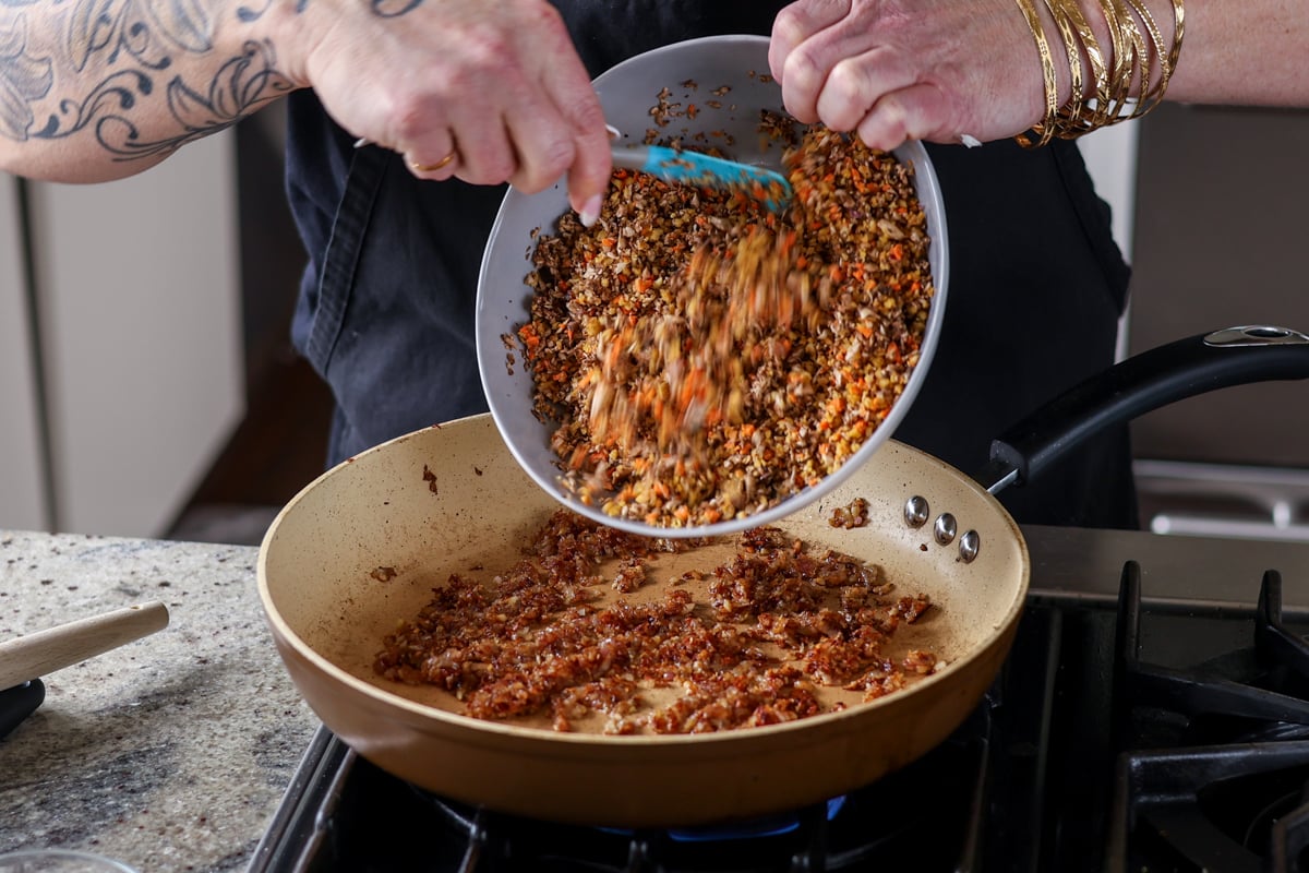 adding loaf mixture to the pan of onions