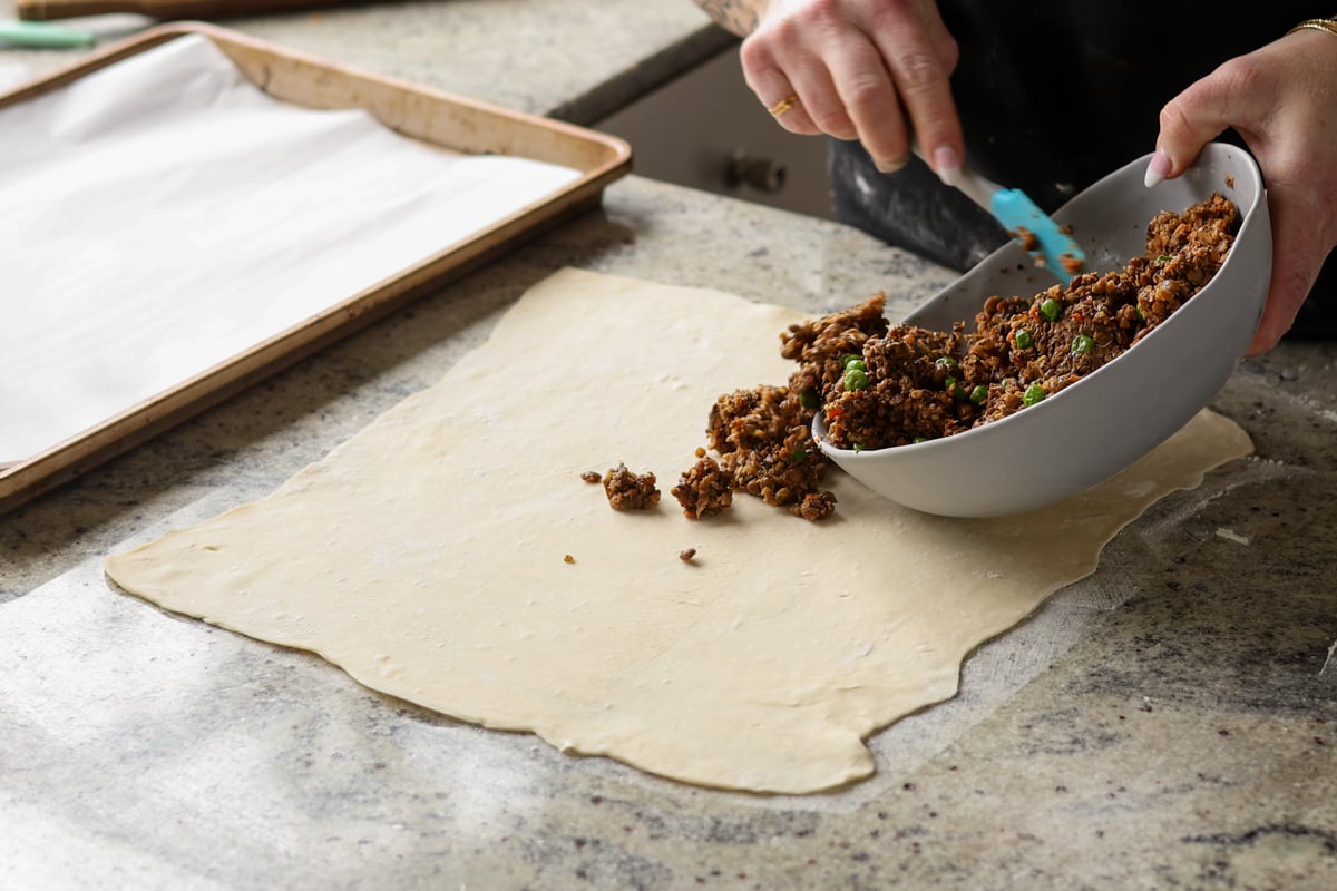 adding the lentil loaf mixture to the puff pastry