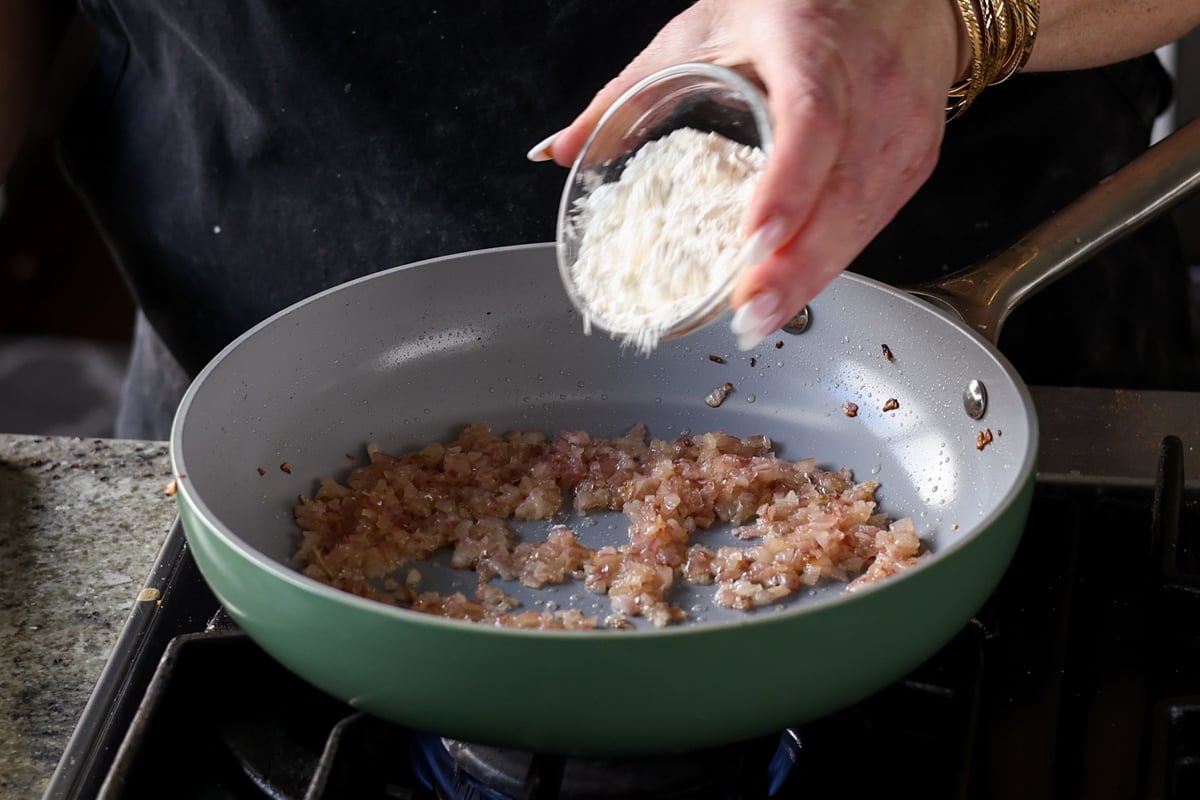 adding flour to the pan