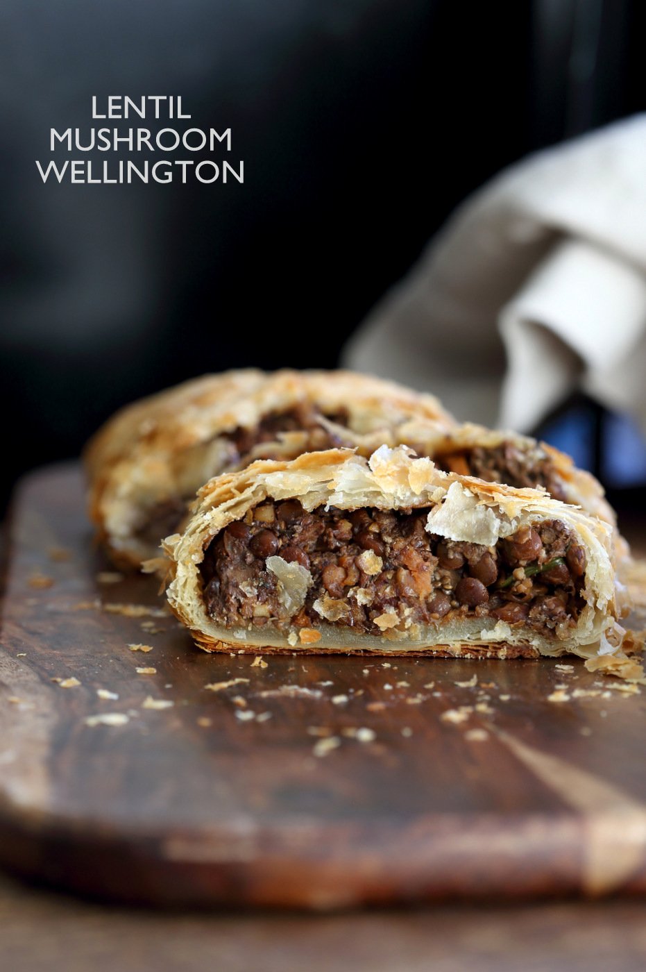 sliced lentil wellington on the cutting board, text overlay