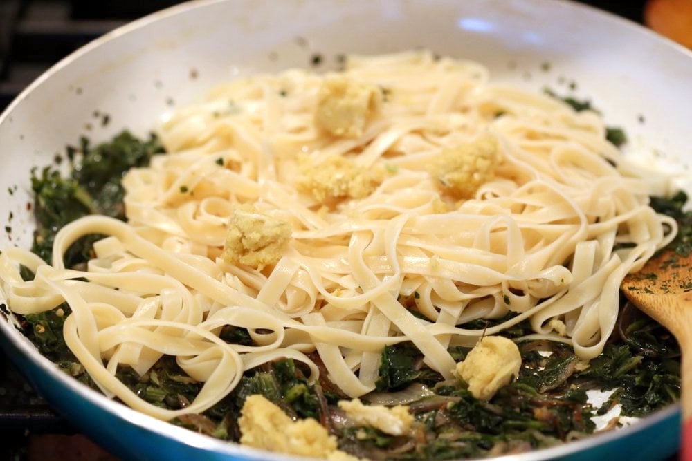 Fettuccine with Caramelized Onions, Greens and Vegan Feta - ish cheese. Easy Weeknight meal. Make the cheese ahead, then the dish is 1 Pot and 30 minutes. #Vegan, can be Gluten-free, Soy-free #veganricha | VeganRicha.com