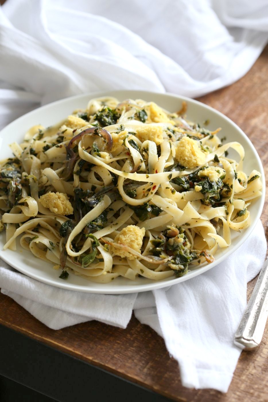 Fettuccine with Caramelized Onions, Greens and Vegan Feta - ish cheese. Easy Weeknight meal. Make the cheese ahead, then the dish is 1 Pot and 30 minutes. #Vegan, can be Gluten-free, Soy-free #veganricha | VeganRicha.com