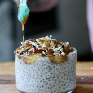 drizzling caramel sauce onto banana chia pudding