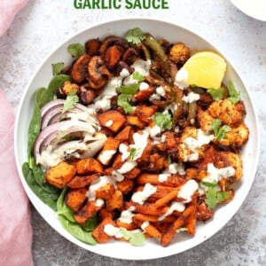 Cajun Roasted Vegetable Bowl with Garlic Sauce. Mushrooms, Cauliflower, Sweet Potato, Peppers, Onions, tossed in cajun spice blend and roasted. Serve in a bowl with crunchy greens and creamy garlic sauce or make wraps or tacos. Vegan #Glutenfree #Soyfree #Recipe. Can be nut-free. | VeganRicha.com