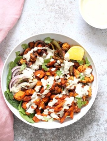 Cajun Roasted Vegetable Bowl with Garlic Sauce. Mushrooms, Cauliflower, Sweet Potato, Peppers, Onions, tossed in cajun spice blend and roasted. Serve in a bowl with crunchy greens and creamy garlic sauce or make wraps or tacos. Vegan #Glutenfree #Soyfree #Recipe. Can be nut-free. | VeganRicha.com