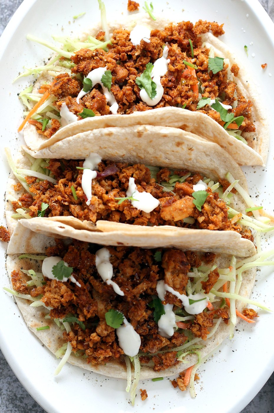 Mango BBQ Soy Curls or Jackfruit Tacos. Shredded Soy Curls or Jackfruit make a an amazing carrier for bbq sauce. Some Mango or other fruit puree takes it to the next level. Serve in sandwiches or tacos with slaw. #Vegan #Glutenfree #Recipe #veganricha | VeganRicha.com