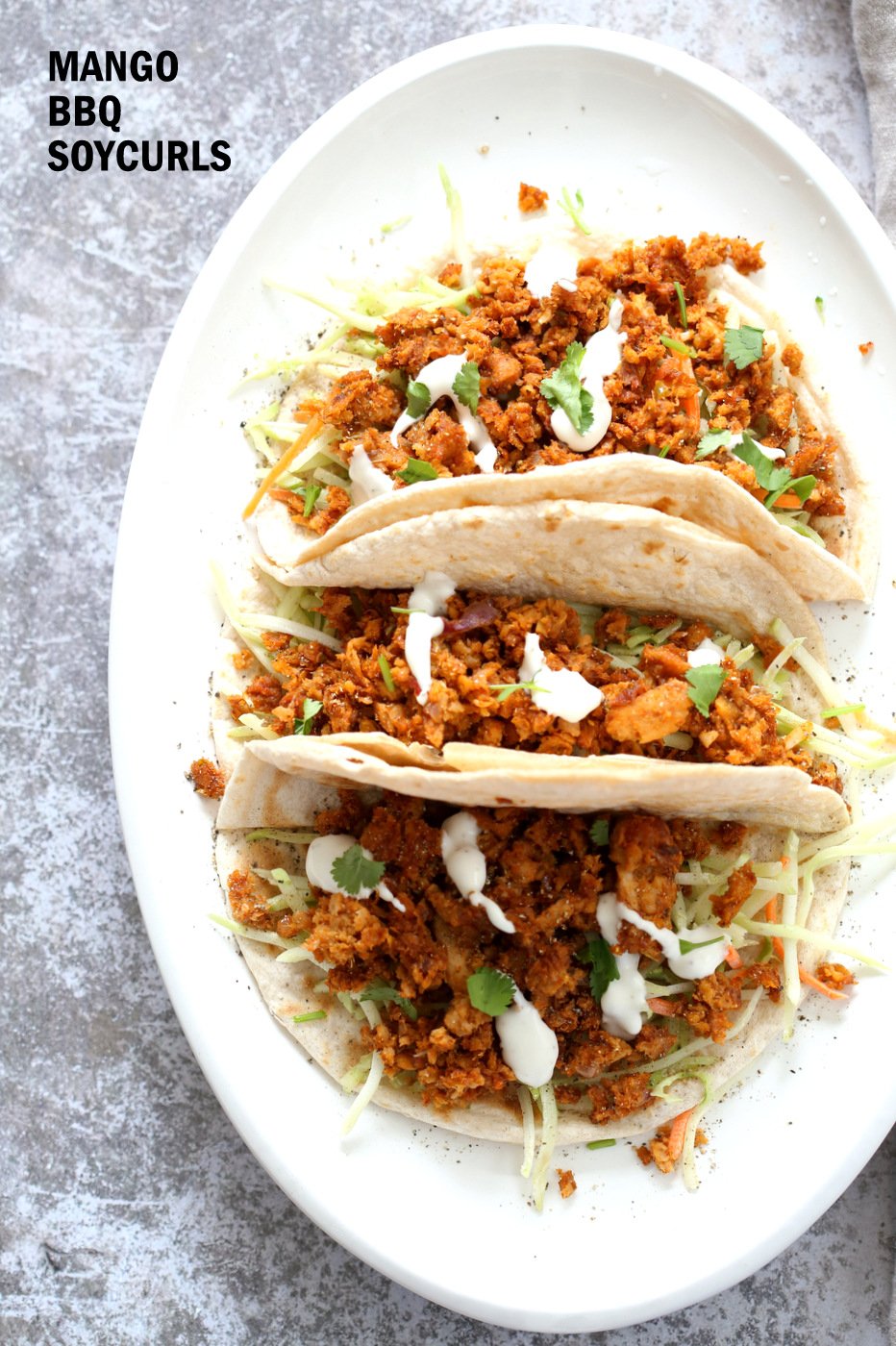 Mango BBQ Soy Curls or Jackfruit Tacos. Shredded Soy Curls or Jackfruit make an amazing carrier for bbq sauce. Some Mango or other fruit puree takes it to the next level. Serve in sandwiches or tacos with slaw. No Added Oil #Vegan #Glutenfree #Recipe #veganricha | VeganRicha.com