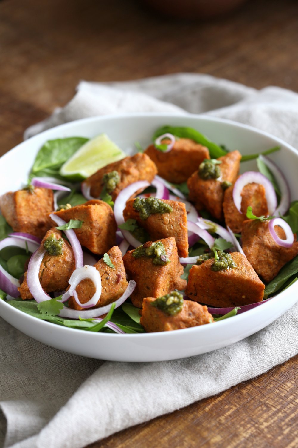 Tempeh Tandoori Tikka Bowl with Cilantro Mint Chutney. Tempeh marinated in Delicious and Flavorful Tandoori Marinade, then baked and served over greens, onions. #veganricha #Vegan #Glutenfree #Recipe. Use vegan meat subs for #soyfree | VeganRicha.com