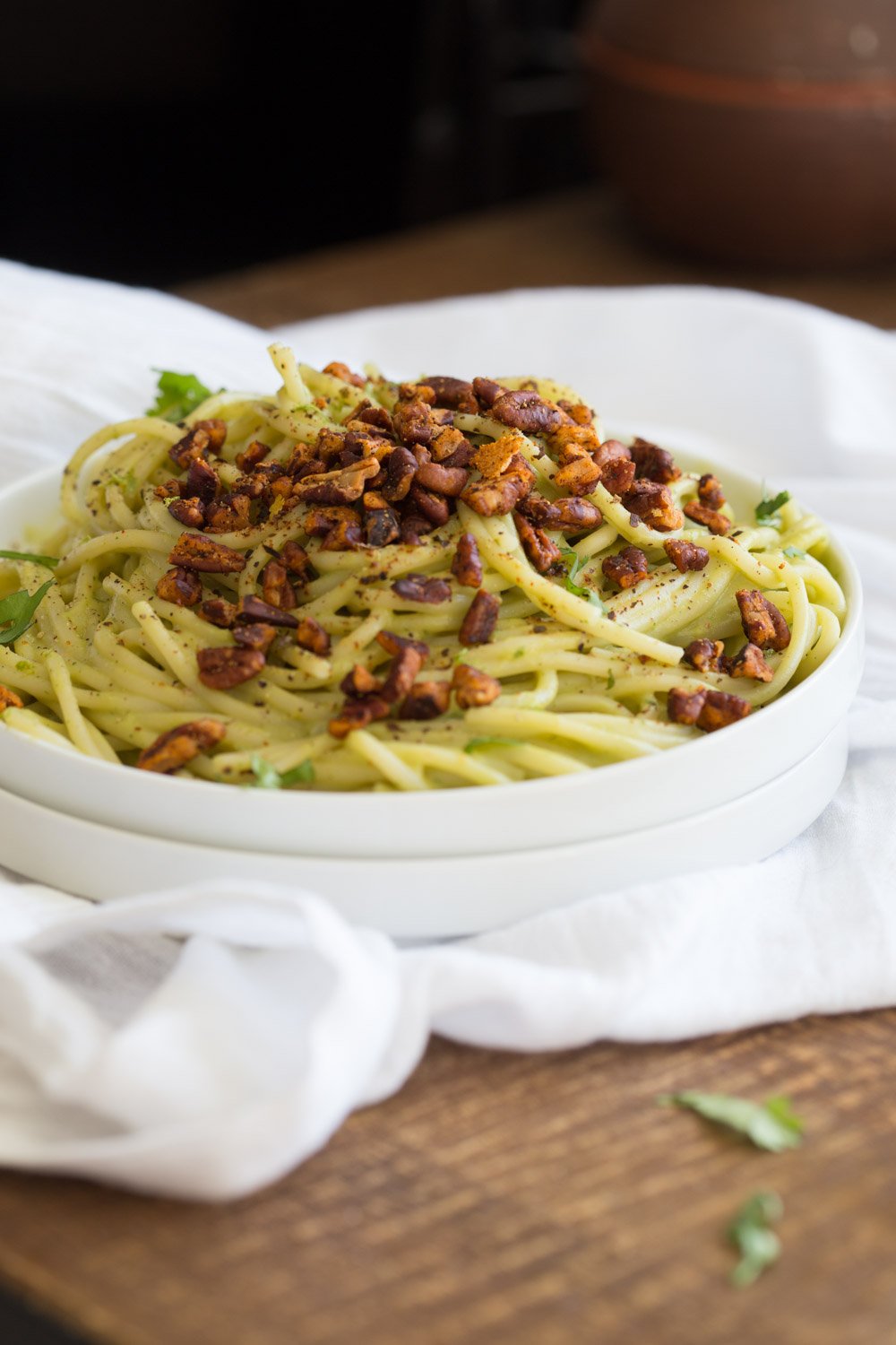 Avocado Pasta with Smoky Pecans served on a white plate