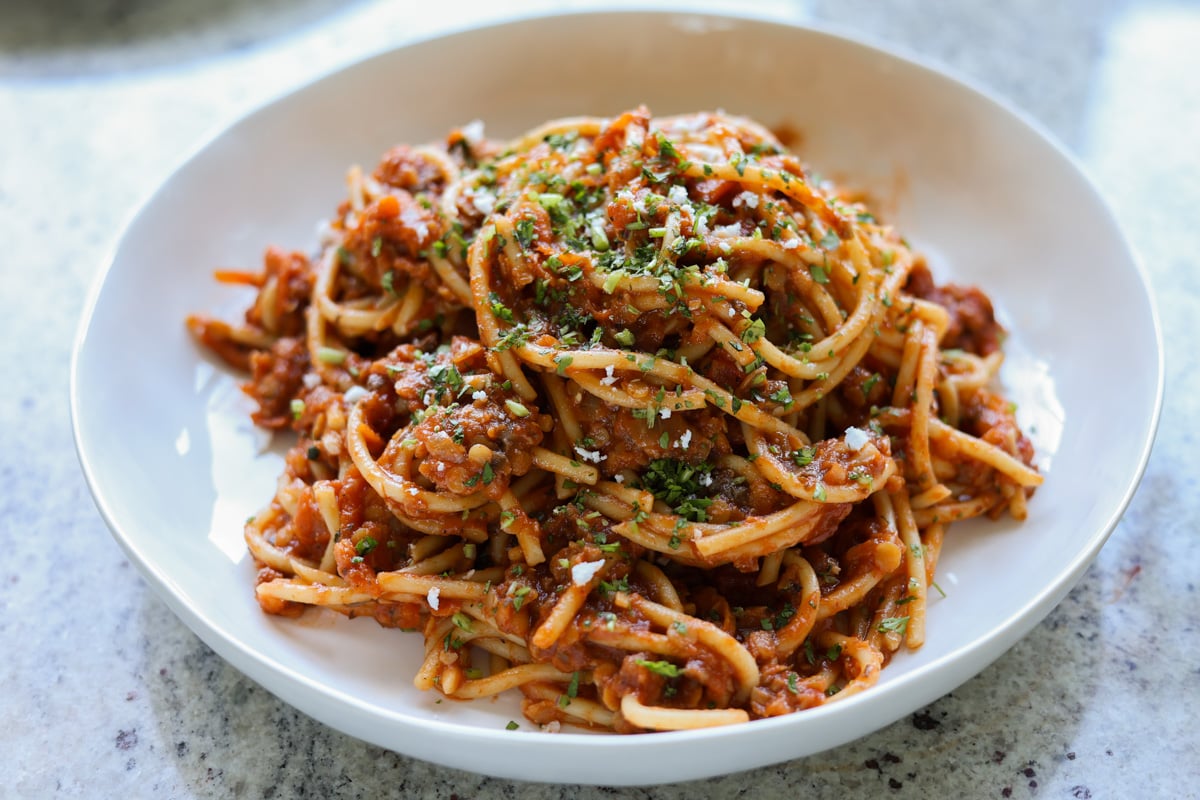 lentil bolognese after mixing into spaghetti in a bowl