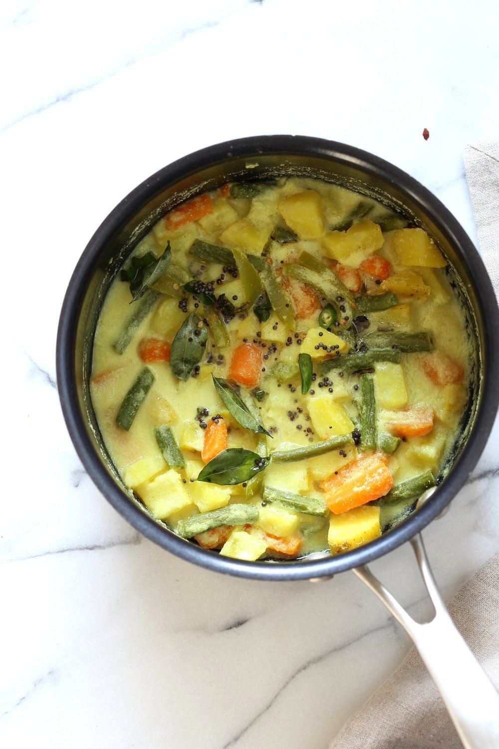 Avial - South Indian Veggie Coconut Curry. Seasonal Vegetables in easy spiced coconut sauce. Serve over rice, flatbread or dosa crepes. #Vegan #Indian #Glutenfree #Soyfree #Recipe #VEGANRICHA