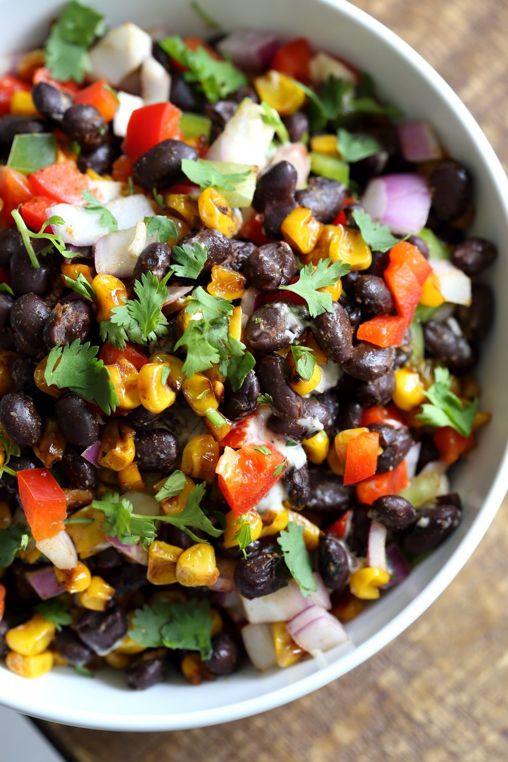 Mexican Street Corn Salad with Black Beans and corn in a white bowl
