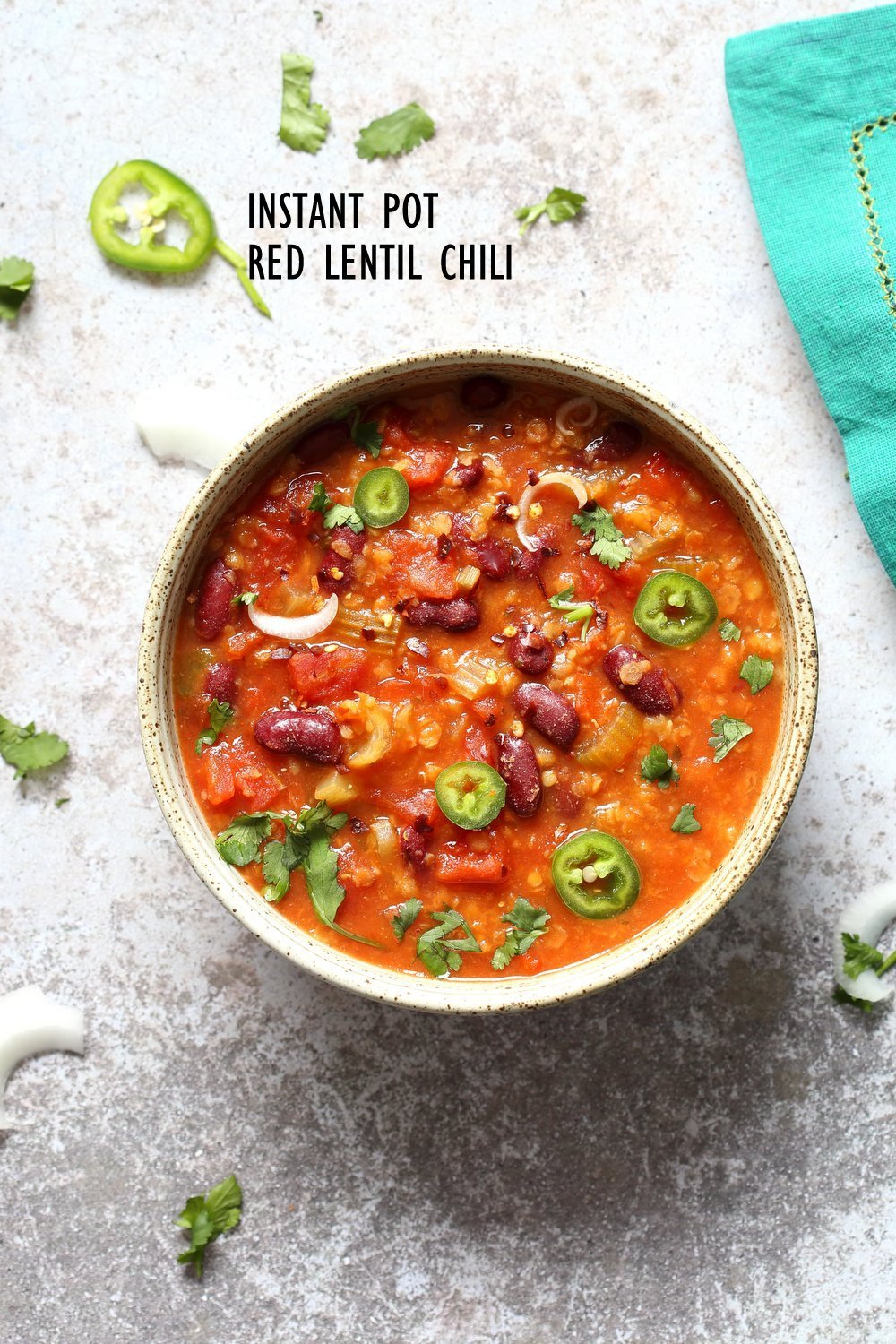 Red Lentil Chili in speckled Bowl kept over concrete. Instant Pot Vegan Chili