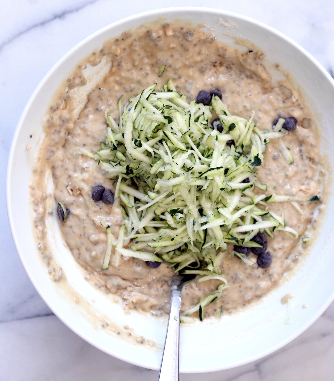 White Bowl with Zucchini Bread Batter and shredded Zucchini