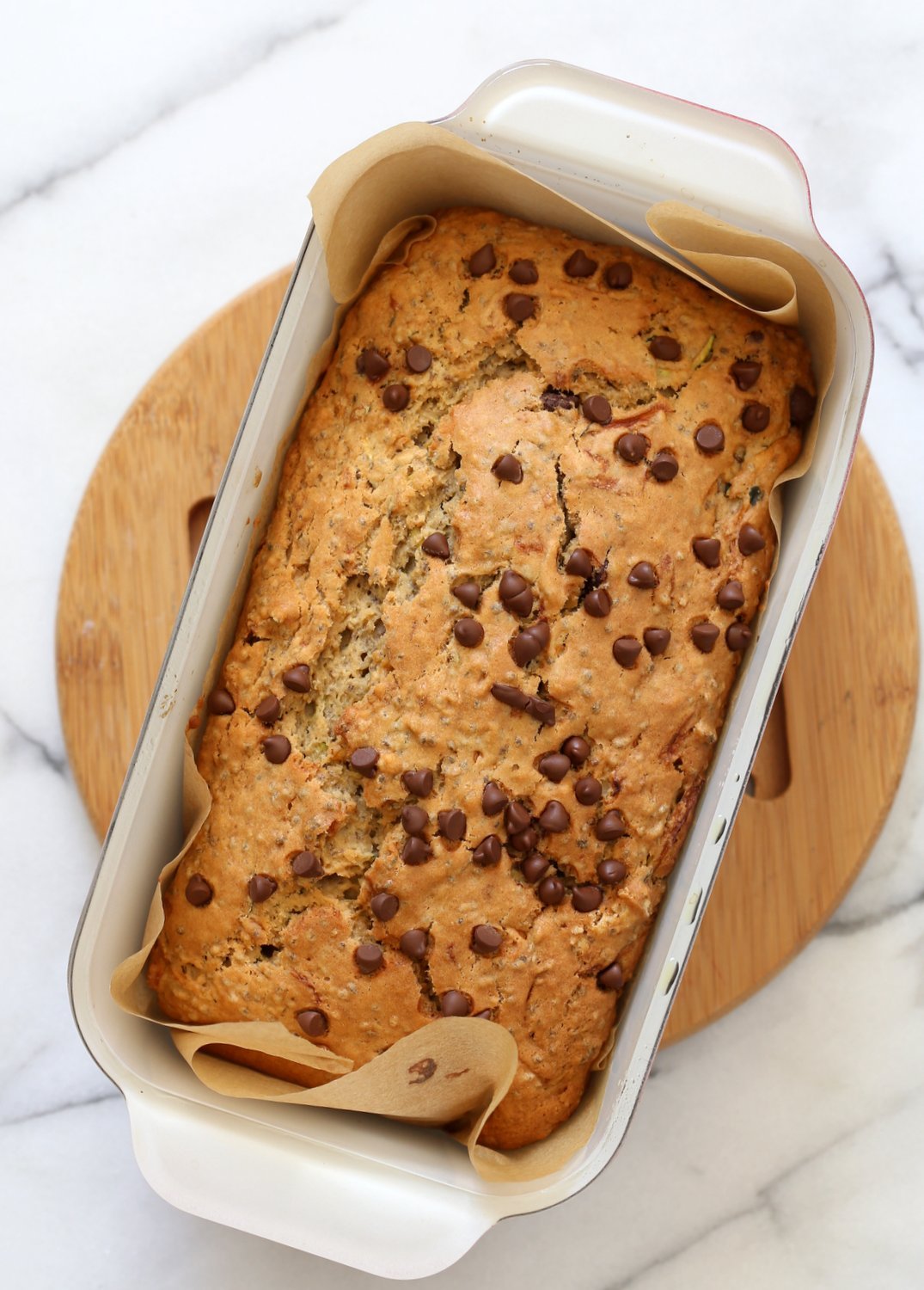 Vegan Zucchini Bread loaf in a Loaf pan over marble