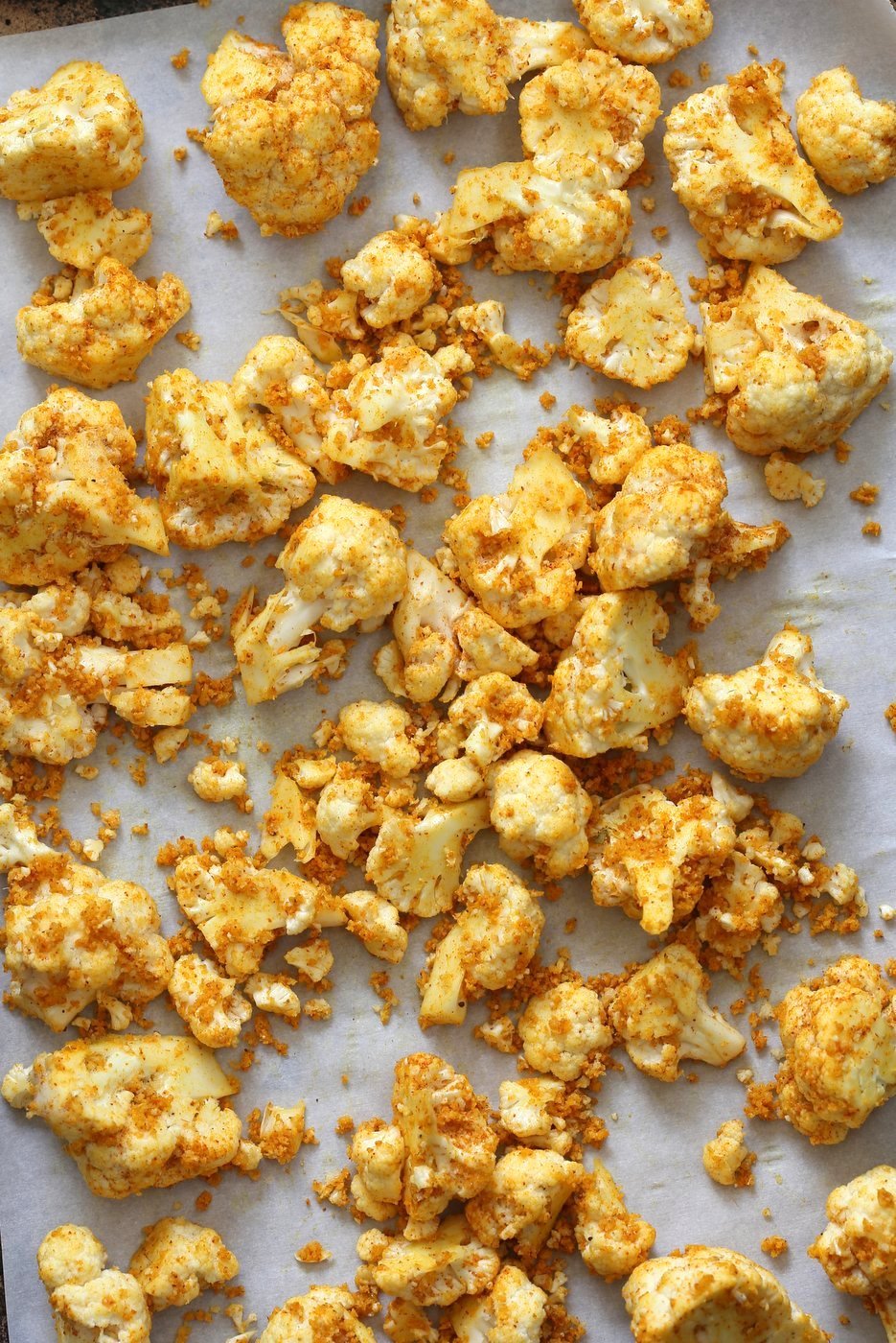 Roasted Cauliflower on Baking Sheet. Turmeric Roasted Cauliflower with Raita Dip. These Delicious Golden Cauliflower Bites are easy and quick. Serve with a dash of lemon or with a Yogurt onion dip or Green Chutney. #Vegan #Soyfree #Nutfree #veganricha #Recipe. Can be #glutenfree