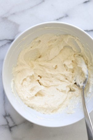 Making our Vegan Malai Burfi- Whipping Cream cheese and butter in a white bowl
