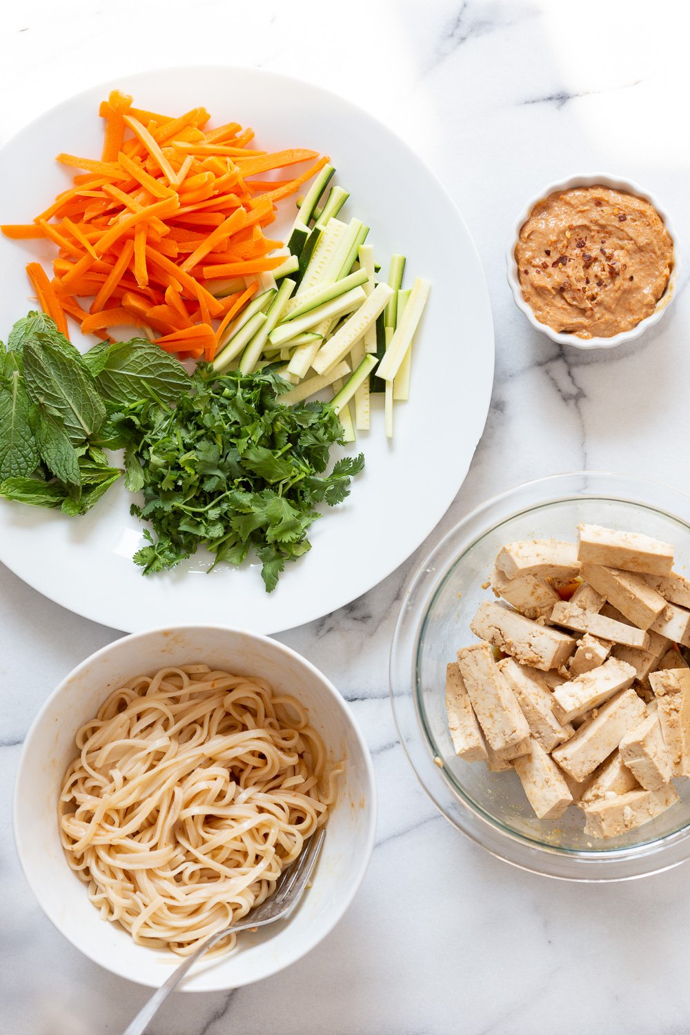 Ingredients for our vegan Fresh Spring rolls in white bowls and plates