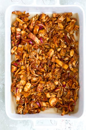 Marinated Jackfruit on parchment lined baking sheet for our Vegan Pulled Jackfruit Sandwiches