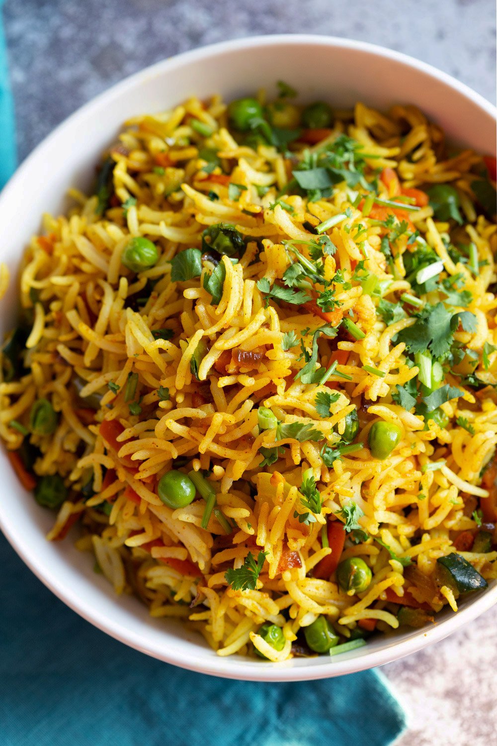 Top down shot of curry fried rice in a white bowl