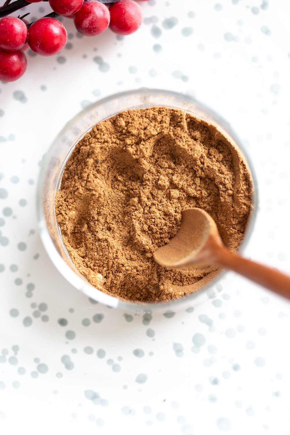 Homemade Gingerbread Spice Mix in a glass bowl on white stoneware