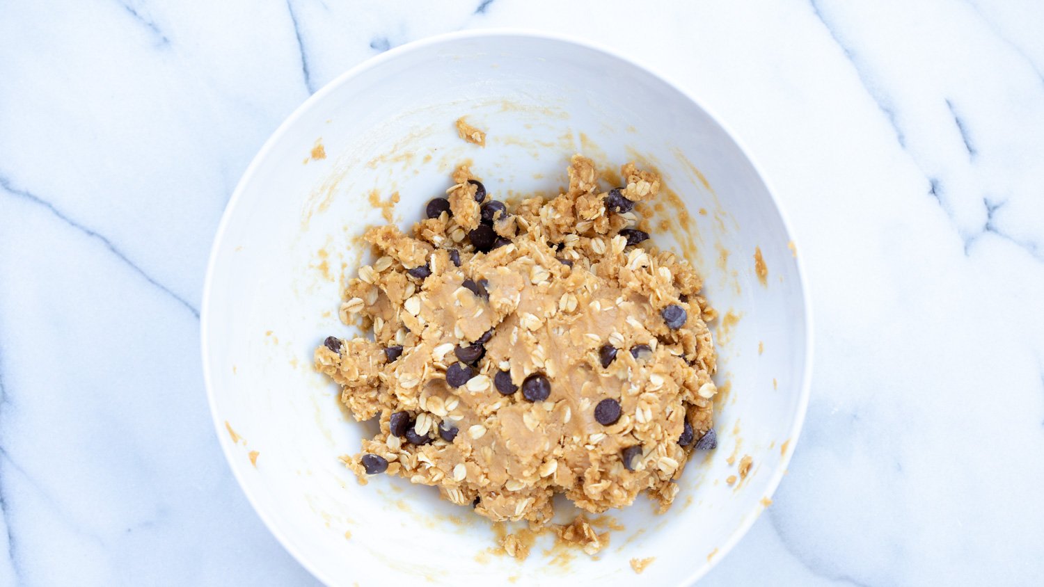 Vegan Peanut butter Oatmeal Chocolate chip Cookie dough in a white bowl