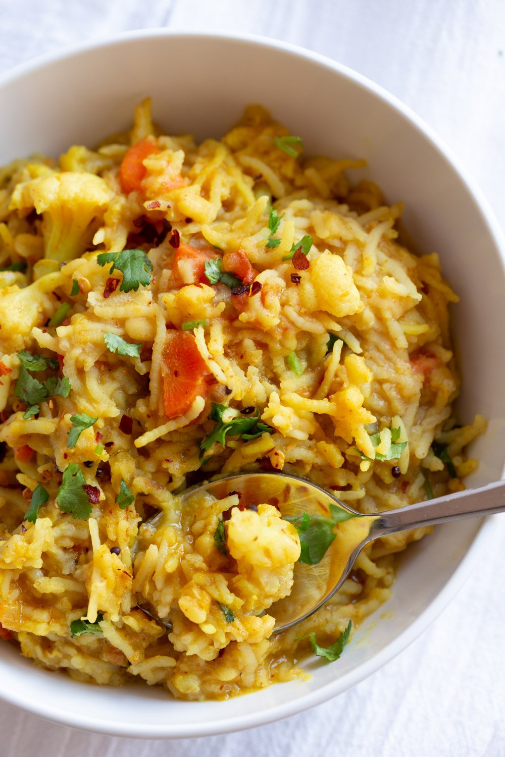Instant Pot Kitchari  a bowl of Instant Pot Kitchari with a spoon