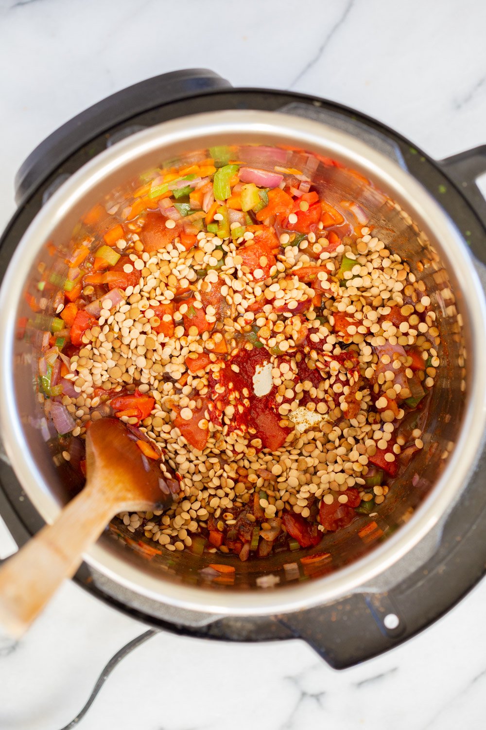 Uncooked Lentils and veggies in Instant Pot pressure cooker for our Vegan Lentil Sloppy joes