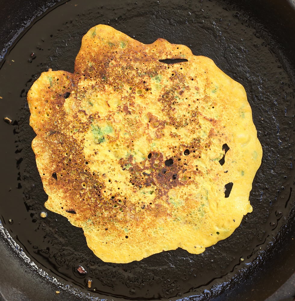 Vegan Chickpea Pancakes on a cast iron skillet