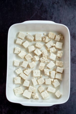Tofu cubes in a white baking dish for our Orange Tofu Recipe
