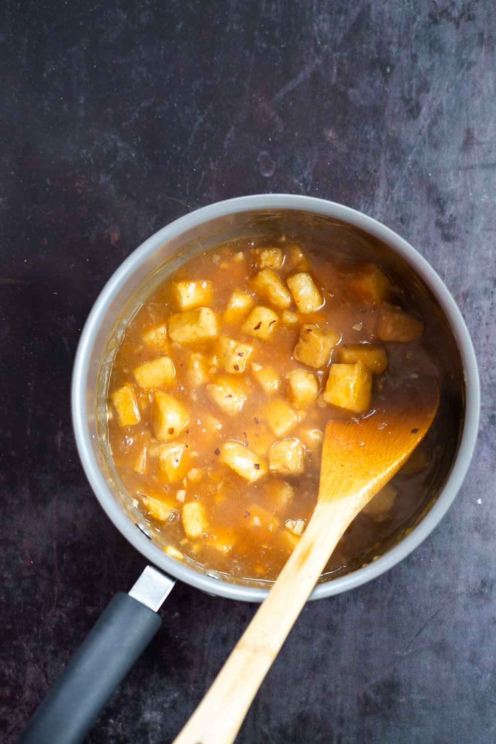 Baked Tofu Mixed with Orange Sauce in a saucepan our Orange Tofu Recipe