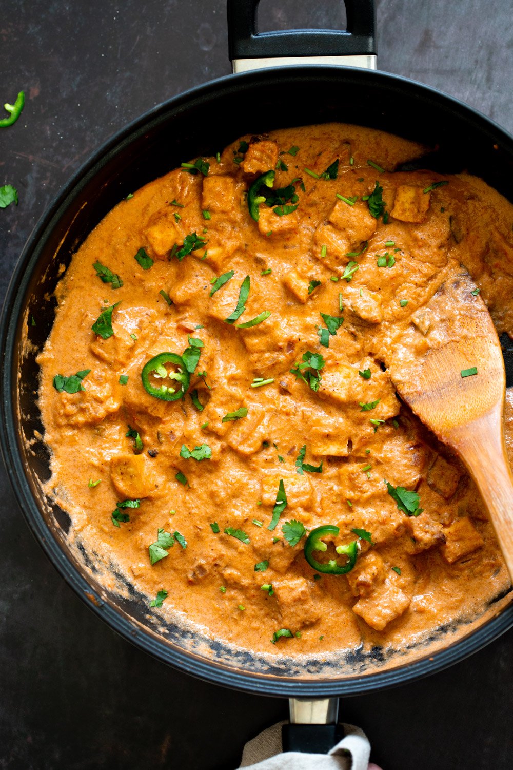 Our Vegan Tofu Amritsari Masala in a black skillet over black tile