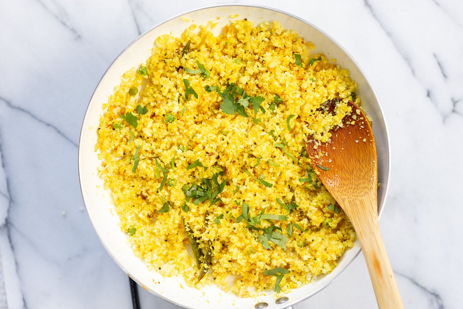 Our Turmeric Cauliflower Rice cooked in a white skillet