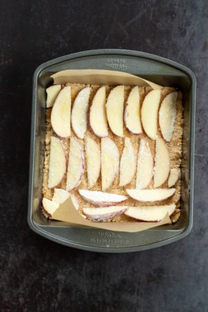 Apple over Crust for our Vegan Apple Custard Squares in a lined brownie pan