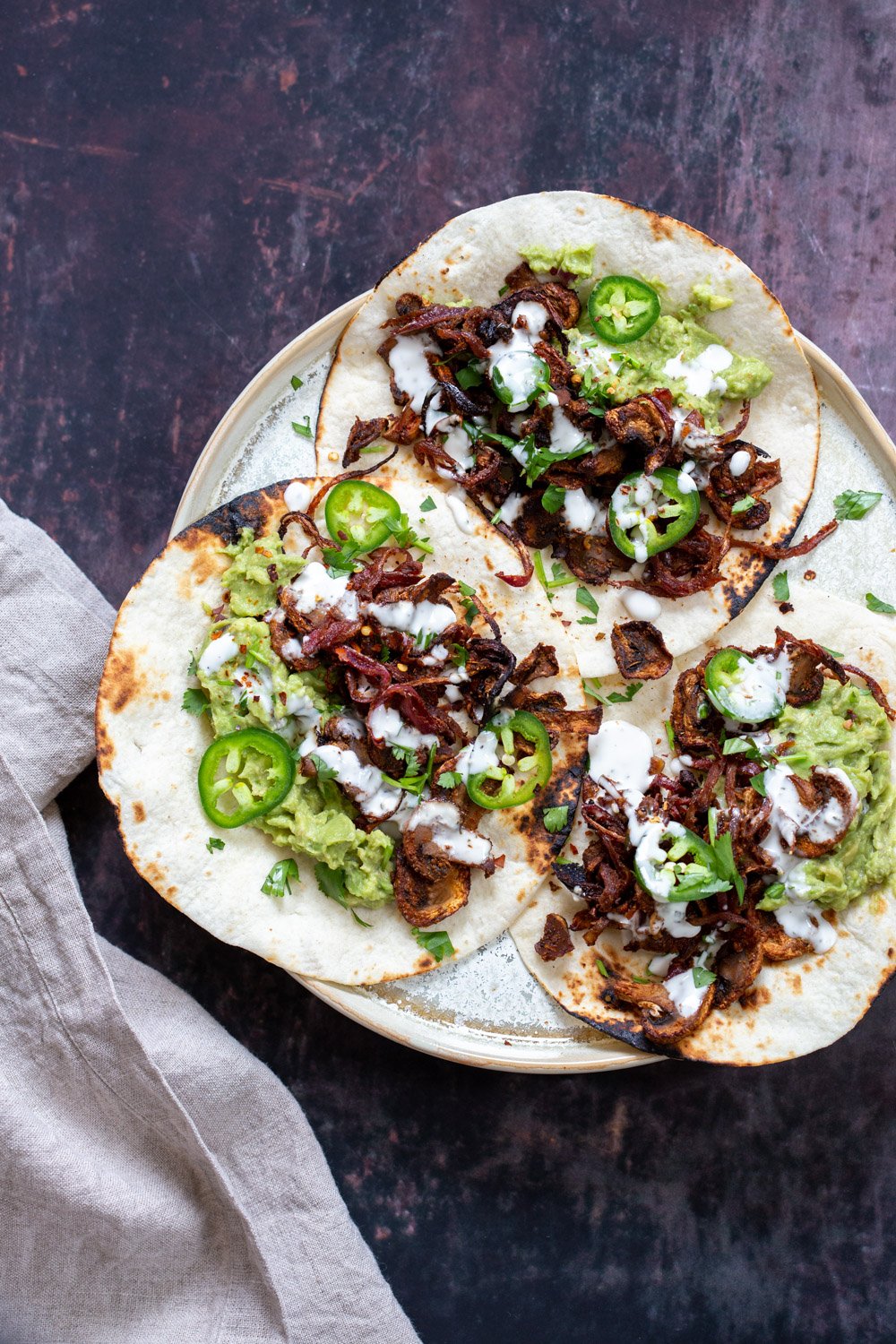 Vegan Carnitas. Mushrooms marinated in Spicy Smoky Zesty Marinade, Baked and served with toppings in tacos, wraps, burritos. Use jackfruit for variation. #vegan #Glutenfree #Nutfree #Oilfree #Recipe. Soyfree option #VeganRicha #mushroomcarnitas #veganarnitas
