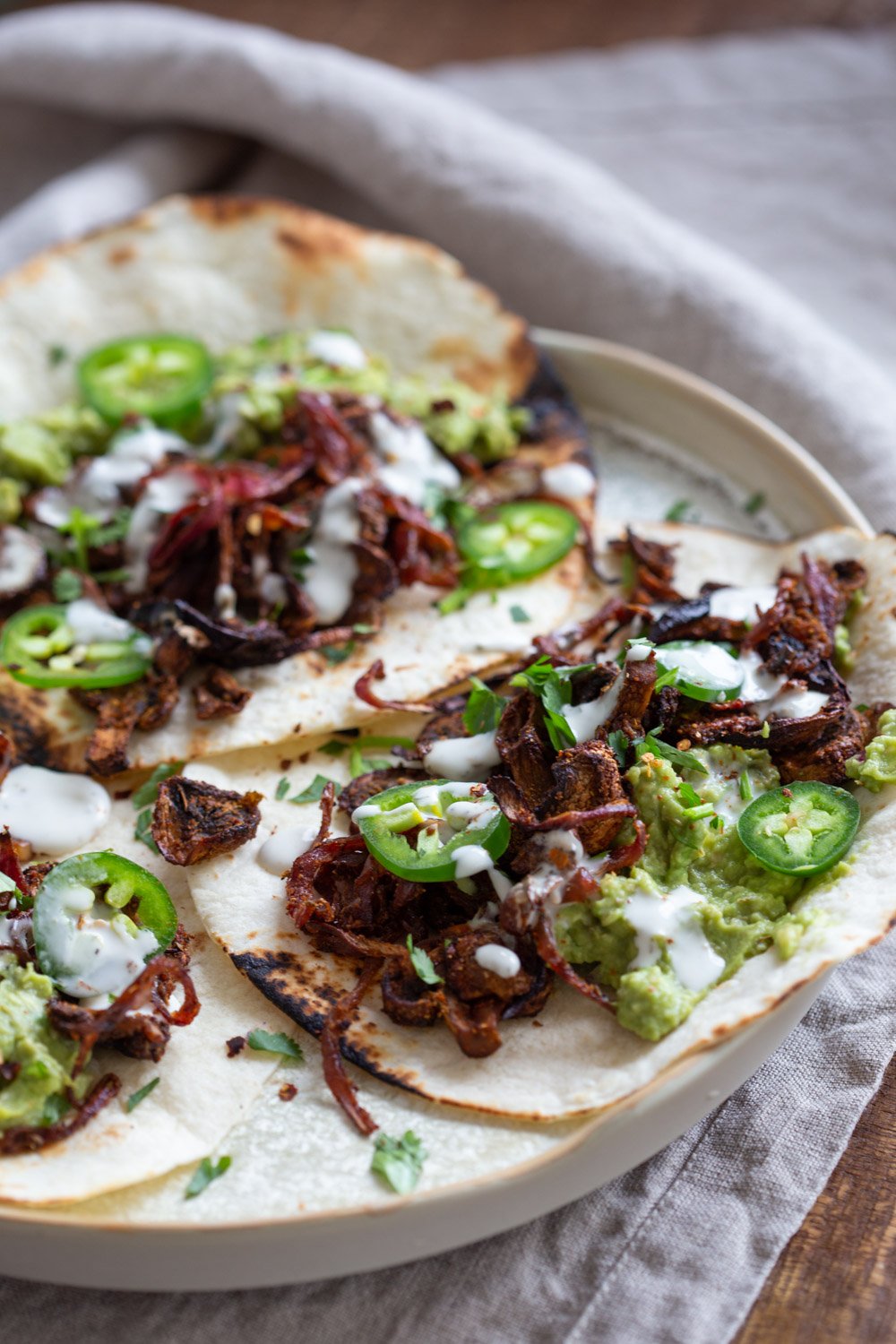 Vegan Carnitas. Mushrooms marinated in Spicy Smoky Zesty Marinade, Baked and served with toppings in tacos, wraps, burritos. Use jackfruit for variation. #vegan #Glutenfree #Nutfree #Recipe. Soyfree option #VeganRicha #mushroomcarnitas #veganarnitas