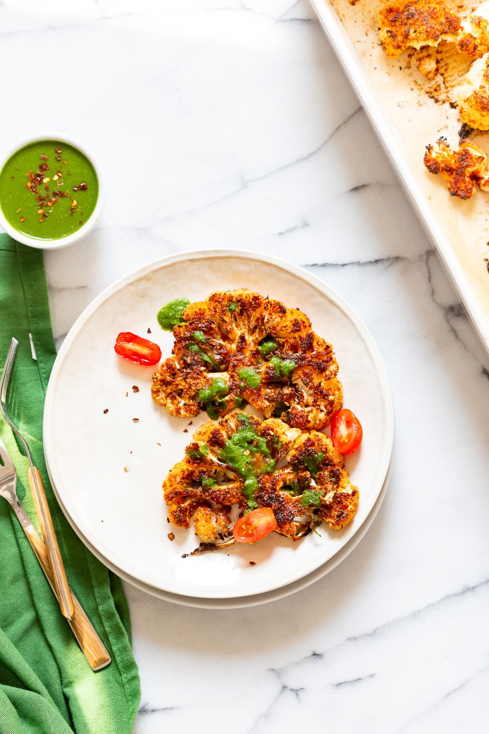 Vegan Cajun Roasted Cauliflower "Steaks" with Chimichurri Sauce. Slice into thick slices or just chop into florets to make this delicious Cajun Cauliflower. Serve with chimichurri or a cooling dressing. #Vegan #Glutenfree #Soyfree #Nutfree #Recipe #veganRicha #cajunCauliflower
