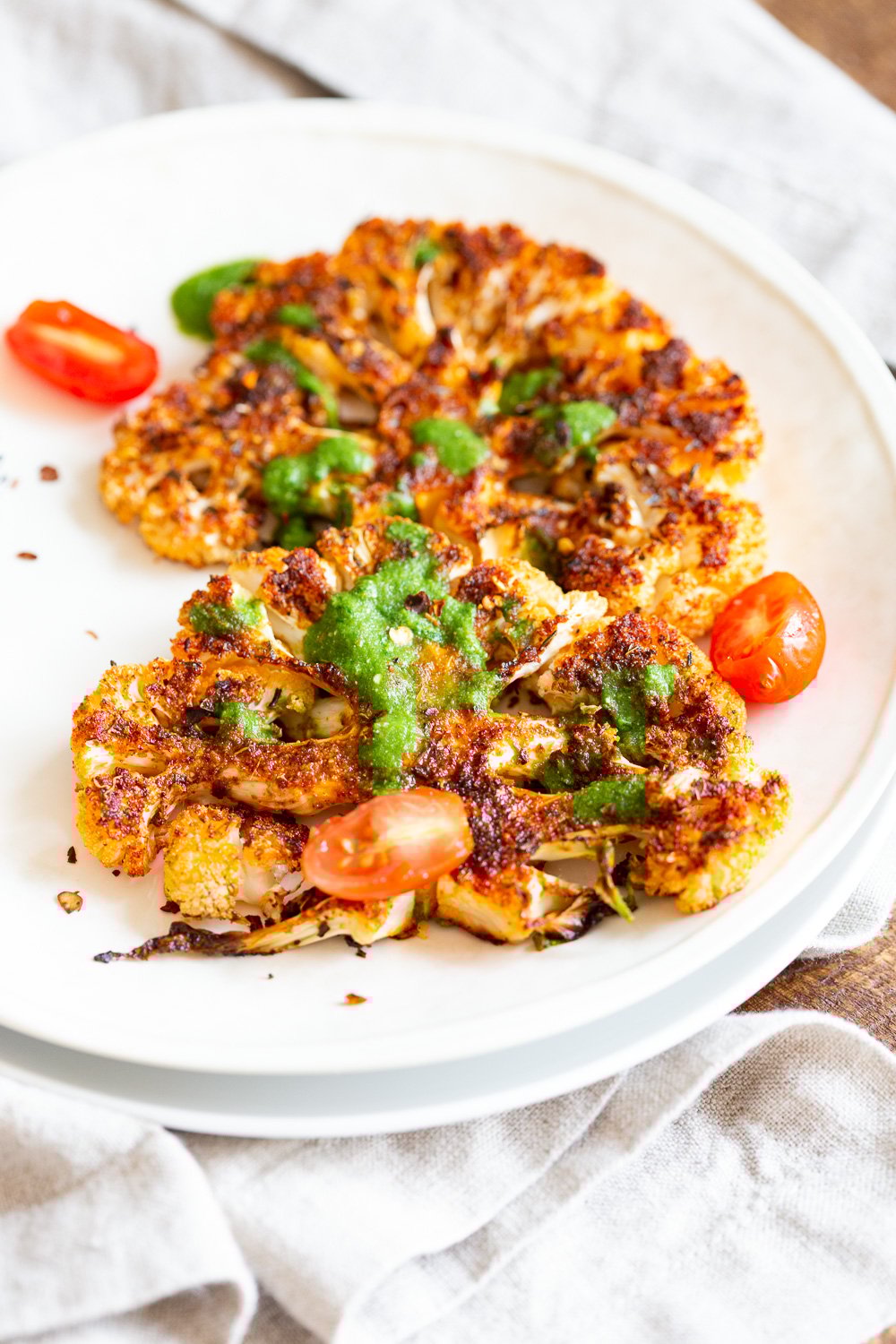 Vegan Cajun Roasted Cauliflower "Steaks" with Chimichurri Sauce. Slice into thick slices or just chop into florets to make this delicious Cajun Cauliflower. Serve with chimichurri or a cooling dressing. #Vegan #Glutenfree #Soyfree #Nutfree #Recipe #veganRicha #cajunCauliflower