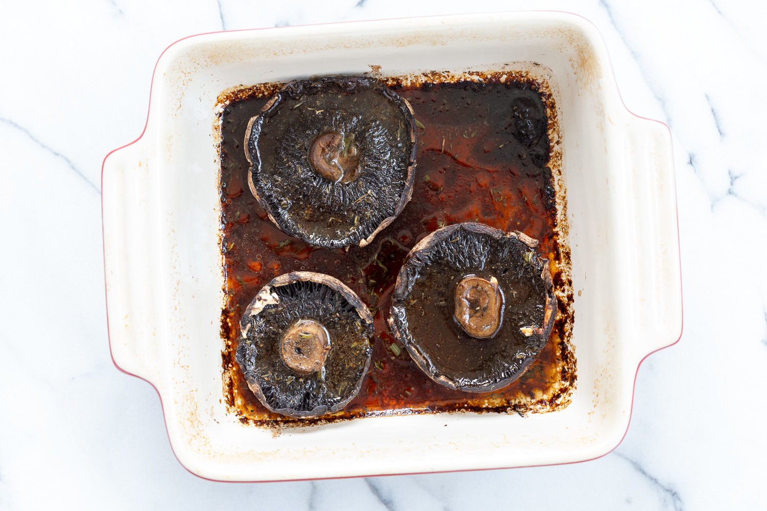Marinated and Baked Portobello Mushrooms in a stoneware dish for Our Creamy Vegan Mushroom Lasagna