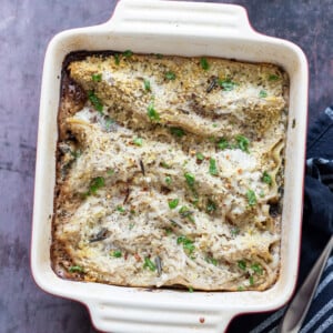 Easy Creamy Vegan Mushroom Lasagna. Marinated and baked Portobello mushrooms layered between creamy garlic sauce and lasagna sheets to make a hearty portobello lasagna. #Vegan #Recipe #veganmushroomlasagna #portobelolasagna #veganricha Can be Glutenfree 